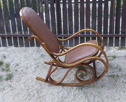 Made with Thonet style features, wooden rocking chair with leather upholstery.