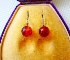 A pair of sterling silver earrings decorated with a pair of ambers with antique studs