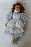 A doll with a porcelain head and body