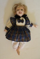 A doll with a porcelain head and body