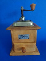 Coffee grinder on a wooden base with metal fittings