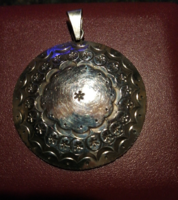 Large, round silver pendant