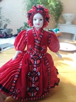 Folk costume doll, with a porcelain head, in a beaded dress