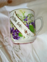 Antique violet cup with lily of the valley