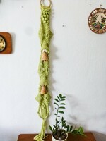 Retro macramé wall decoration with wooden bells