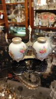 Porcelain salt and pepper shaker with silver top.