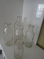 Five old milk bottles. Together.