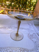 A glass bowl with a polished handle for serving footed cakes