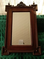 Old-German wooden frame with a carved flower on the frame, decorative mirror.