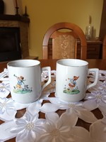 Pair of old Zsolnay children's mugs with fairy tale patterns