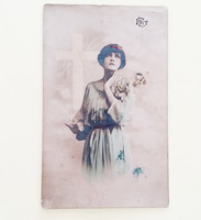 Old postcard circa 1920. Woman postcard with flowers cross