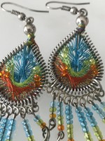 Handmade earrings made of colorful thread and pearls