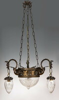 Old bronze chandelier decorated with plastic dragon heads