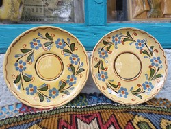 A pair of marked folk ceramic wall plates