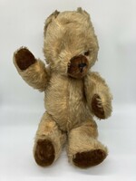 Old long-furred toy teddy bear with movable arms