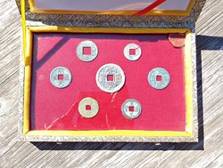 7 Pcs. Old Chinese coin behind a glass plate, in a padded box