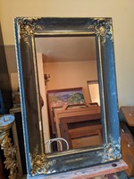 Antique mirror in a carved wooden frame