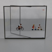 Transparent retro slide projector image in a metal frame. Bicycle & scooter