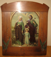 Antique relief image of the holy family in a painted frame