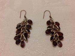 Earrings decorated with purple glass lenses