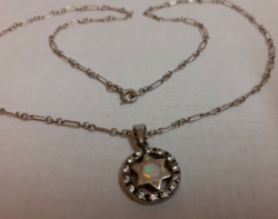 Silver chain with an opal stone in the middle in a six-pointed star circle with a pendant studded with white zirconia stones