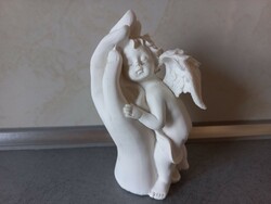 Angel figure in protective hands