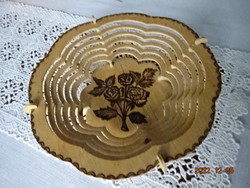 Wooden table centrepiece, with a burnt-in rose pattern in the middle. He has!