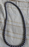 Metallic gray string of beads