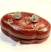 A pair of earrings with diamonds.