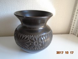 Flawless hollow black ceramic vase with embossed floral patterns
