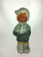 Fired glazed ceramic figurine of a small child in a hat