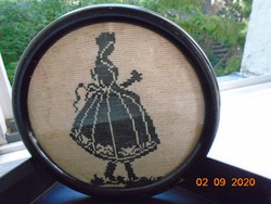1930 Needle tapestry milfs in ornate Hungarian folk costume, silhouette in a round frame