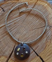 Thick twisted silver necklace with a special round pendant