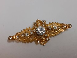 Gold-plated white brooch studded with sparkling white stones