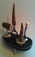 Old hunter's set of drink openers and stoppers on a wooden holder (bottle opener, corkscrew, etc.)