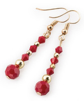 Red faceted sphere and biconical crystal earrings with tiny golden pearls.