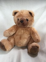 Large brown teddy bear with dark brown soles