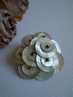 Decorative shell brooch with small pearls.