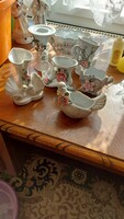 Small porcelain decorative objects, vases and candle holders, in a romantically kitsch presentation