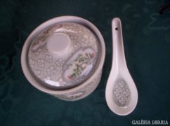 With a small porcelain spoon with a lid. XX