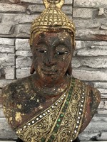 Buddha statue head on a wooden base