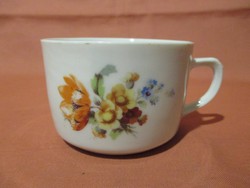 Tea cup with bouquet of flowers