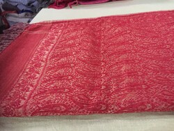 It can be a brick red scarf with a cashmere pattern, or a table centerpiece or runner