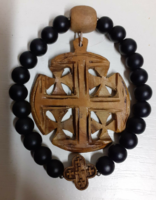 A wooden frame rubber bracelet made of black pebbles in good condition with a carved wooden pendant