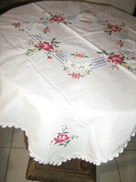 Beautiful pink tablecloth embroidered with a small cross-stitch crocheted drop edge