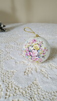 A beautiful porcelain ball holding a potpourri with a bouquet of flowers