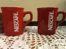 Pair of Nescafé coffee cups.