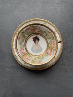 An old cafe set made of fine thin porcelain, decorated with roses and a portrait of a lady