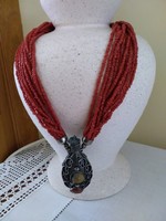 Multi-strand coral-colored handmade necklace with vial pendant