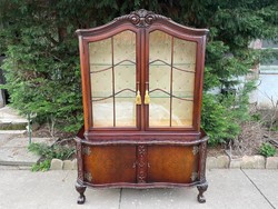 Wonderful baroque display case with curved lion legs with root veneer.
